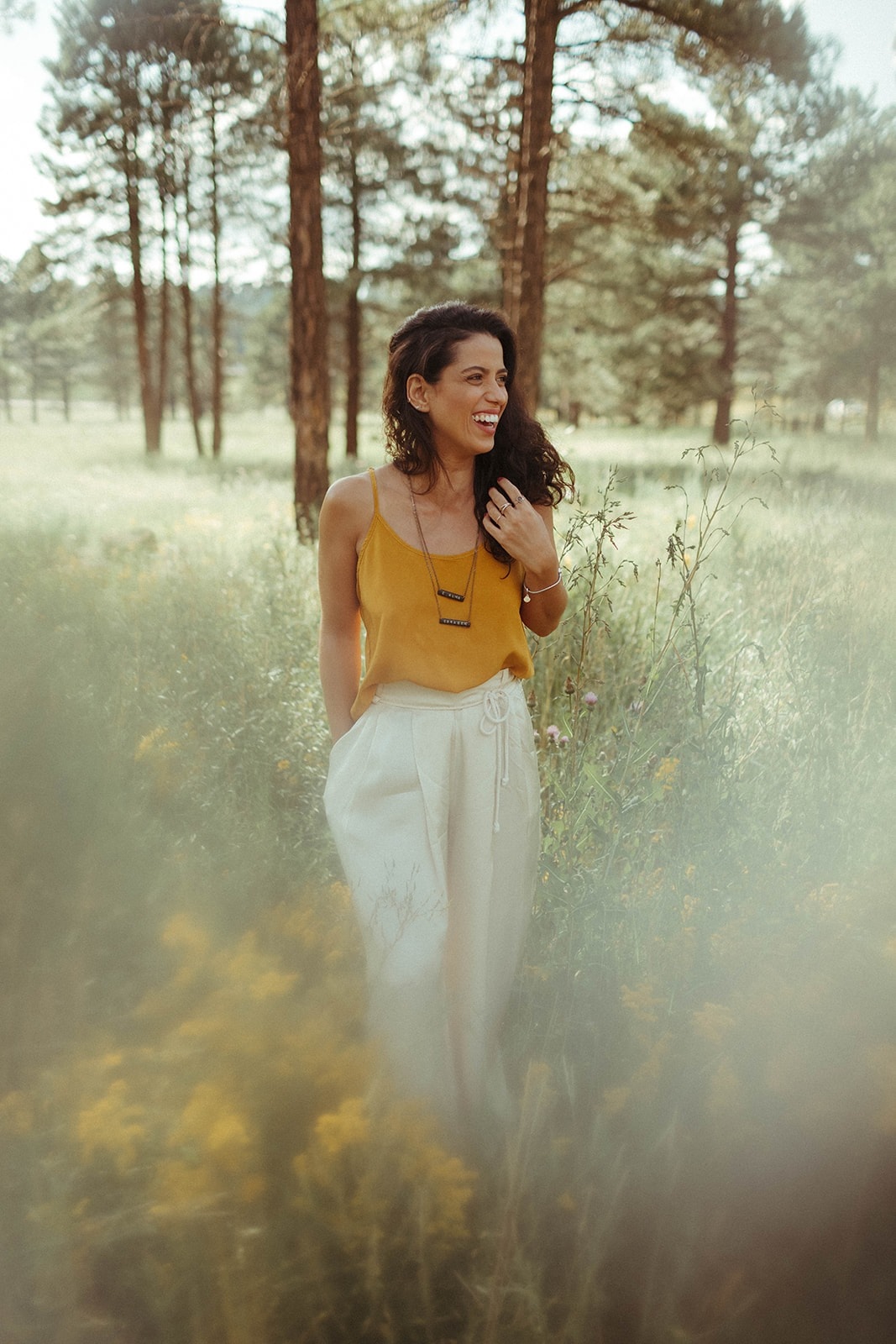 Ana Camargos smiling in a sunlit field