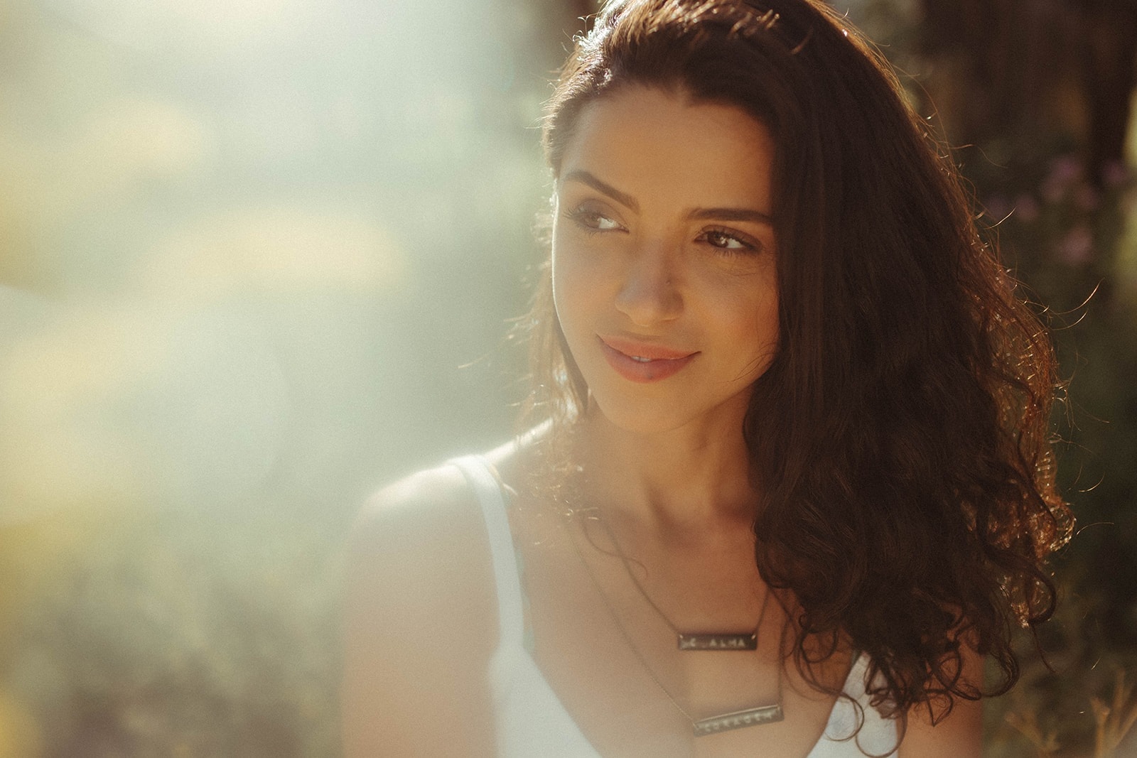 Ana Camargos smiling in a sunlit field